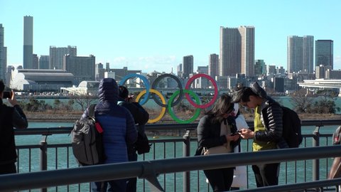 TOKYO, JAPAN - FEB 2020 : The five ring symbol of the Olympic Games at Odaiba. Japan will host the Tokyo 2020 summer Olympic and Paralympic. Crowd of people taking photo of the symbol.