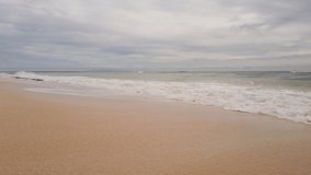tropical beach sea. beautiful beach view with calm waves on cloudy sky. HD Video Clip.