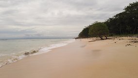 tropical beach sea. beautiful beach view with calm waves on cloudy sky. HD Video Clip.