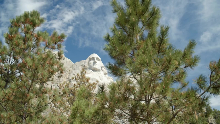mount rushmore faces through the trees slow motion 