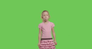 girl wear pink t-shirt chewing bubble gum over green screen background, Child on chroma Key 4k raw video footage slow motion 60 fps