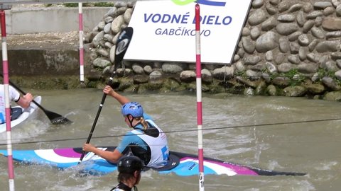 BRATISLAVA, SLOVAKIA - CIRCA AUGUST, 2017: A high shot of a Slalom Kayak Athlete navigating a sequence of canoe slalom gates on a white water course