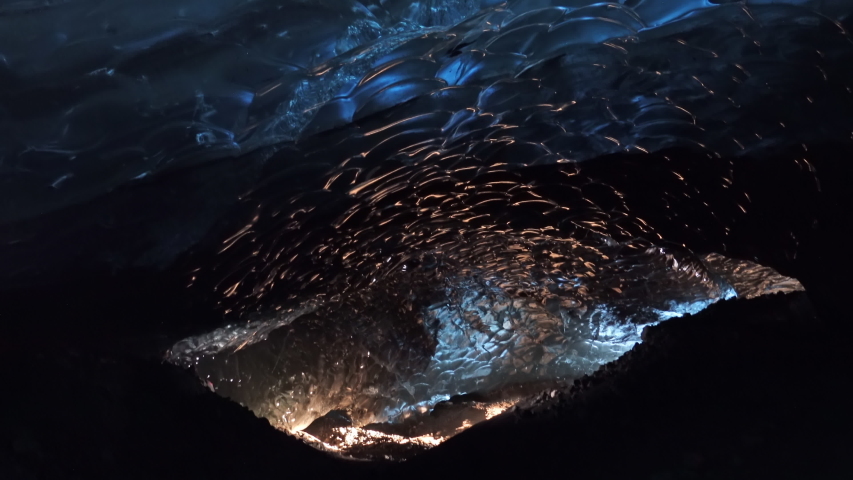 Golden light entering blue glacier ice cave Iceland.mov
