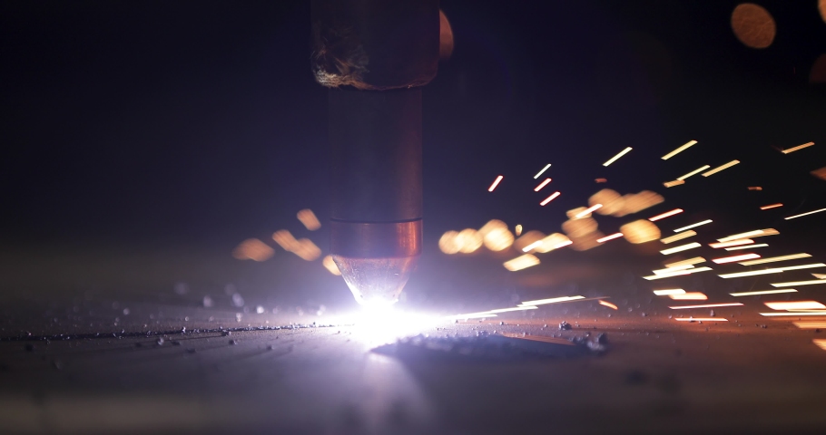 Plasma cutting of metal with a cnc. A plasma cutter cuts a workpiece from a sheet of metal. Laser cutter in production. Industrial metal cutting by plasma laser. 4K video. High definition video Royalty-Free Stock Footage #1046325595