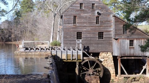 Yates County Mill water flowing with wooden building and waterwheel in Raleigh North Carolina