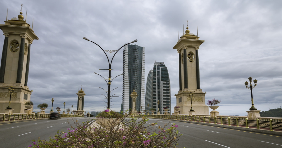 Time lapse at the Seri Gemilang Bridge in the artificial grown government city of Putrajaya, Malaysia 40km outside of Kuala Lumpur. In the background the skyscraper of Putrajaya. 