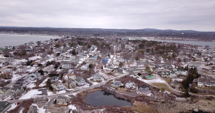 Drone moving over New Hampshire town in winter