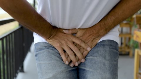 Close up of a man with hands holding his crotch, Urinary Tract Infection concept Painful Bladder Syndrome and interstitial cystitis