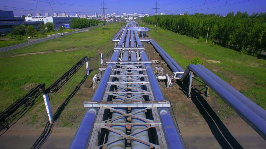 AERIAL Pipes with hot water. Heat carrier steel pipes from CHP, heat and power centers supply heat and water to the city. Infographics and motion design illustrates the energy flows through the pipes. Royalty-Free Stock Footage #1046340553