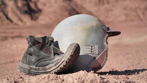 Tilt view of old boot and motorcycle helmet in Sinai desert, Egypt