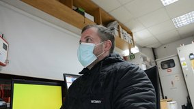 guard man with a mouthguard mask on face at workplace