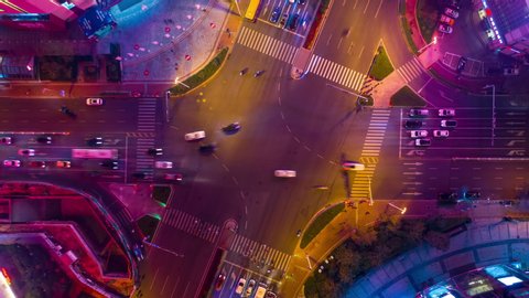 night time illumination qingdao city famous downtown traffic street crossroad aerial topdown timelapse 4k china