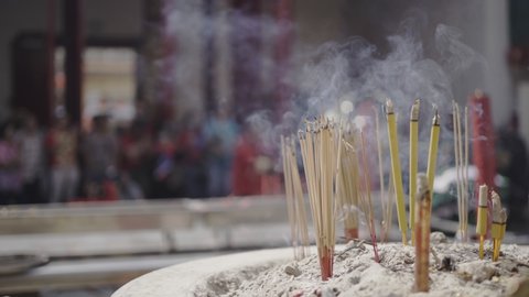 Joss sticks in Chinese temple emitting smoke