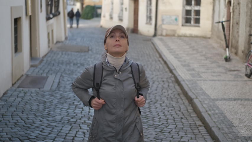 Walk on the cobblestones. Girl tourist walks on the old streets of Europe.