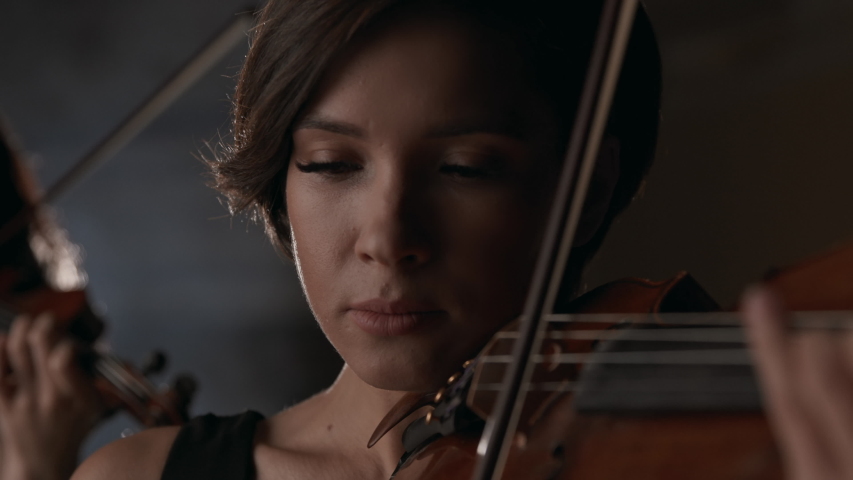 Symphonic Team of Three Music Players with Classic Wooden Violins. Equipment of Talented Women Playing Popular Acoustic Melody Indoors. Work of Pretty Woman as Violinist and Skill of Musician Closeup Royalty-Free Stock Footage #1046380126