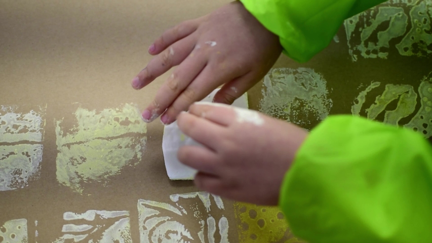 Close-up of a children in art therapy class drawing, painting and practicing engraving art. Child education in primary school at art class in Spain.