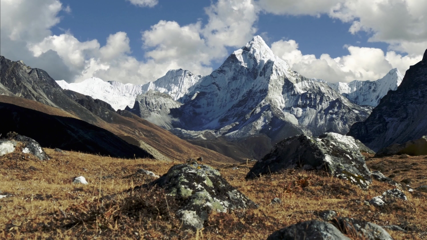 Magnificent view of Ama Dablam mountain on the way to Everest Base Camp trek. Nepal, Himalayas mountains. Steadicam shot of snowy Himalayas and running clouds. UHD, 4K Royalty-Free Stock Footage #1046398390