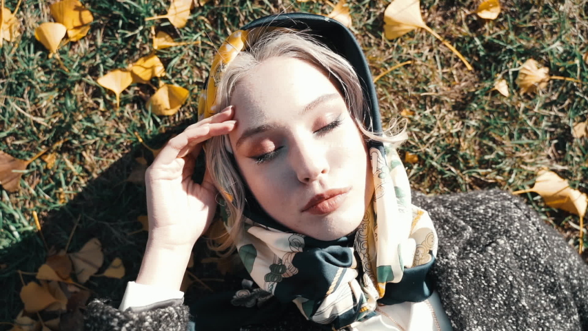 Young adult lady resting in park at sunny day