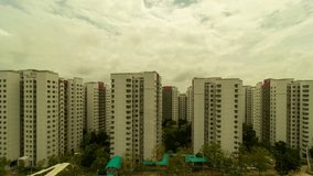 Ultra high definition 4k time lapse video of moving clouds over apartment buildings or flats in Punggol estates with neighborhood traffic in Singapore 3840x2160