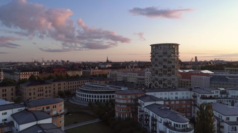 Aerial view of high-rise buildings in Stockholm, Gärdet at sunset. Drone shot flying by, Östermalm cityscape skyline in the background. Capital city of Sweden