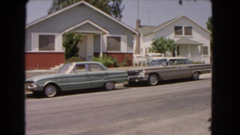 BARSTOW CALIFORNIA USA-1966: Random Scene Where Are Two Cars In A Street In Front Of Two Houses