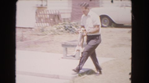 BARSTOW CALIFORNIA USA-1966: Dog Is Being Trained By Its Owner In The House