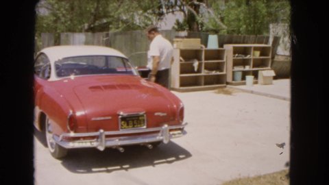 BARSTOW CALIFORNIA USA-1966: Man Closing The Door Of The Big Red Car