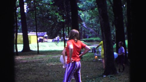 GALENA ILLINOIS USA-1967: A Crowd Of People Are Gathered In A Park For A Cookout And Playing Games