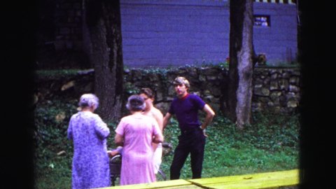 GALENA ILLINOIS USA-1967: A Couple Of People Enjoying Themselves As They Talk To Easy Other