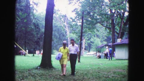 GALENA ILLINOIS USA-1967: Man Walks With Woman In Park On Pleasant Day For Outdoor Activities