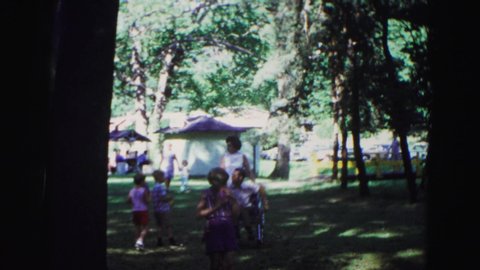 GALENA ILLINOIS USA-1967: Mother And Children Talking At Outdoor Festival Near Tents