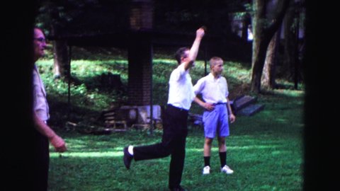 GALENA ILLINOIS USA-1967: People Playing A Game With Lawn Jarts On Sunny Day In Park Area