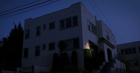 Los Angeles, CA, USA 01/26/2020 - A typical California apartment exterior, establishing shot with a locked off angle during the day. Run down building with white stucco exterior.