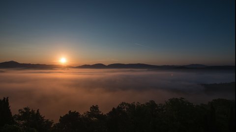 A beautiful time lapse of a sunrise over the Umbria Hills in Italy. The shot starts pre dawn with cloud low in the valley, as the sun rises it create a beautiful image, sun breaking through the cloud.