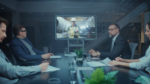 Diverse Group of Board Members, Executives and Management in the Meeting Room, Have Conference Video Call with Team of Engineers, Production Line Specialists. Optimizing Company Production and Growth