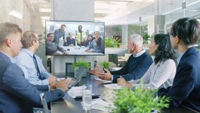 Diverse Group of Board Members, Executives and Management in the Meeting Room, Have Conference Video Call with Team of Engineers, Production Line Specialists. Optimizing Company Production and Growth - Powered by Shutterstock - Get 15% off with code: PIKWIZARD15