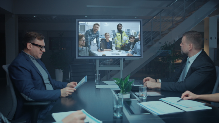 Late at Night Diverse Group of Executives and Management in the Meeting Room, Have Conference Video Call with Team of Engineers, Production Line Specialists. Optimizing Company Production and Growth | Shutterstock HD Video #1046470915