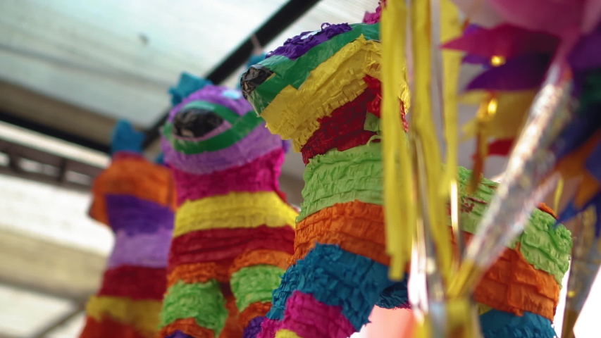 Mexican pinatas hanging in a market Royalty-Free Stock Footage #1046488327