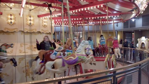 Burnaby, Canada - Jan 2, 2020: People riding on vintage carousel, Burnaby Village Museum