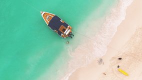 Tropical boat sailing on clear turquoise water of caribbean sea