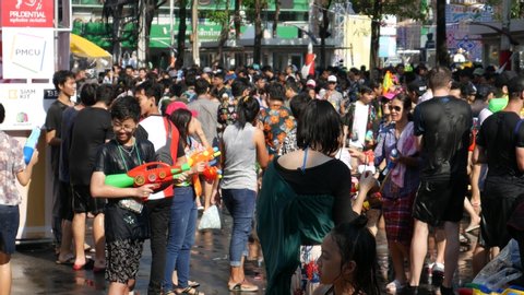 Bangkok, Thailand-April 14, 2018: Locals and tourists celebrate Songkran Festival, Traditional Thai New Year. People play water, and use water guns to enjoy the festival.