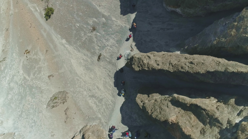 Overhead view, tourist trekking expedition, narrow path over scree slope, Nepal