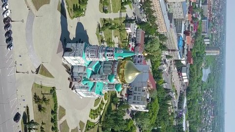 Vertical video. The Cathedral of the Assumption of the Blessed Virgin Mary, panoramic views of the city. Omsk, Russia, Aerial View, Point of interest