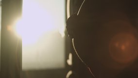 Pregnant woman stroking her stomach while standing near the window during dawn - Powered by Shutterstock - Get 15% off with code: PIKWIZARD15