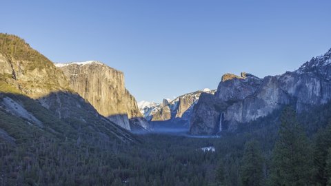 Yosemite Valley Tunnel View at Sunset in Winter. Sunny Evening with Moon. California, USA. Time Lapse
