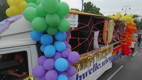 VIENNA AUSTRIA June 16 2018 – LBGT rainbow parade, gay pride parade, Regenbogenparade at the Ringstrasse Wien, drag queens walking along, camera panning upwards to a party truck with sound