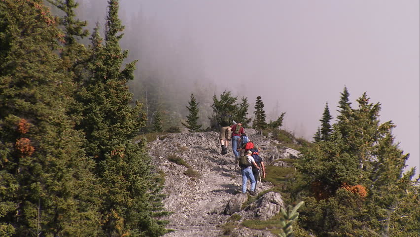 Hikers climbing mountain trail in the Rocky Mountains