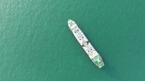 Aerial top view of the ship carrying the lpg and oil tanker in the sea port with ship. For energy export and import business for transportation trade. footage video 4k B-roll scene.