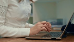 Business woman using laptop computer at desk, female hands typing on notebook keyboard studying working, close up view. 4k video