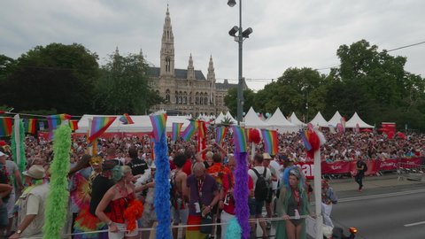 VIENNA AUSTRIA June 16 2018 – LBGT rainbow parade, gay pride parade, Regenbogenparade at the Ringstrasse Wien, close up party truck with music passing by, background spectators and town hall, sound